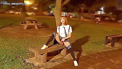 Asian redhead in red stockings enjoys foot fetish on a bench